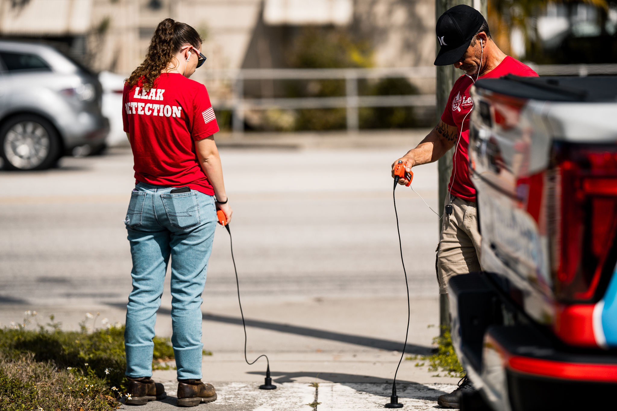 Two people monitoring a leak in concrete. 